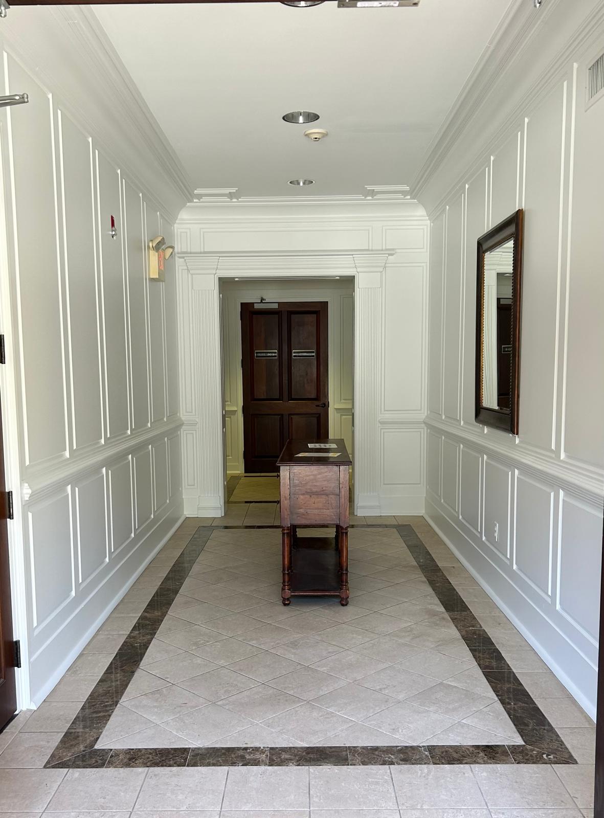 Finished entry hall with paneled walls