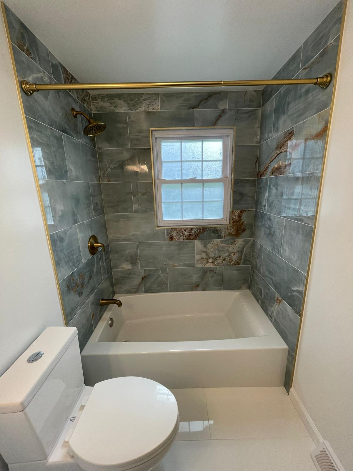 Bathroom with tub and tiled walls
