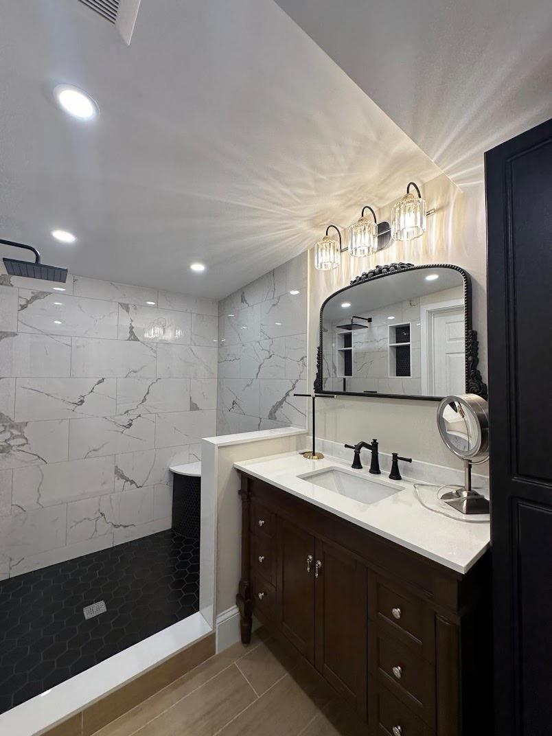 Bathroom with vanity and tiled walls