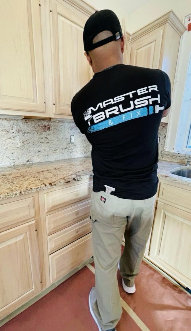Worker beside kitchen cabinets