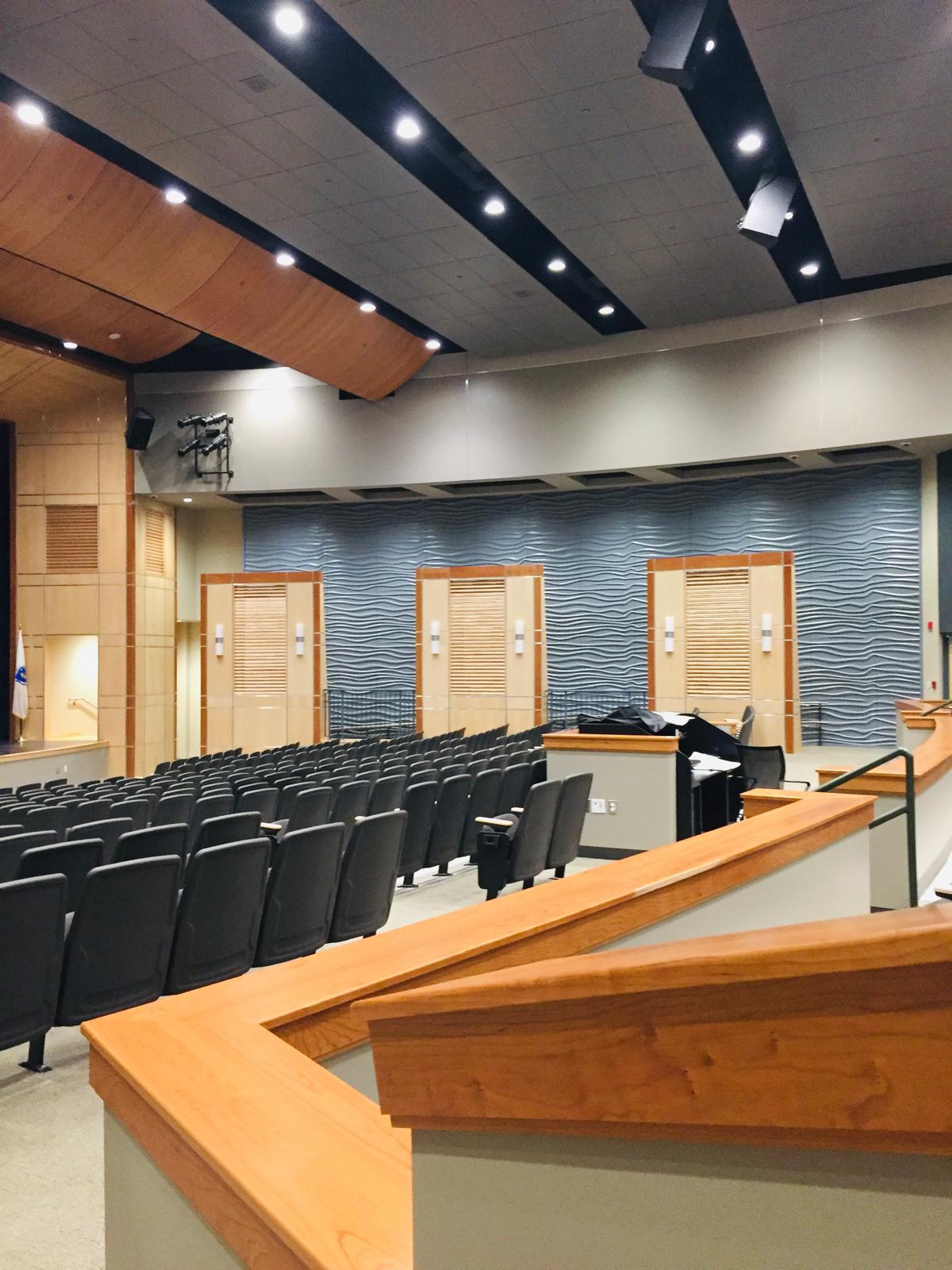 Finished auditorium with seating and wood details